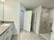 Beautiful bathroom featuring a granite vanity, tiled floor, and glass-enclosed tiled shower at 8949 Se 159Th Ln, Summerfield, FL 34491