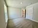 Carpeted bedroom with an exterior view, a double door closet, and a view into the hallway at 8949 Se 159Th Ln, Summerfield, FL 34491