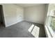 Bedroom with neutral carpet, a double door closet, and large window at 8949 Se 159Th Ln, Summerfield, FL 34491