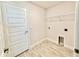 Bright laundry room with tile floors and a wire storage rack at 8949 Se 159Th Ln, Summerfield, FL 34491