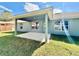Covered patio and backyard with green grass at 8949 Se 159Th Ln, Summerfield, FL 34491