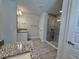Bathroom showcases a glass shower, granite countertops and a tile backsplash at 9869 Se 157Th Ln, Summerfield, FL 34491