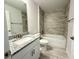 Well-lit bathroom with a tub-shower combo, granite vanity, and tile accents for a clean and functional space at 9869 Se 157Th Ln, Summerfield, FL 34491