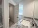 Bathroom featuring granite countertops, and a separate toilet room for added privacy at 9869 Se 157Th Ln, Summerfield, FL 34491