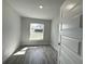 Cozy bedroom with wood-look tile flooring and a window providing natural light at 9869 Se 157Th Ln, Summerfield, FL 34491