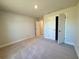 Spacious bedroom with carpet floors, closet, and neutral walls providing a blank canvas for personalization at 9869 Se 157Th Ln, Summerfield, FL 34491