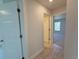 Bright hallway features tile flooring and neutral walls, connecting different areas of the home at 9869 Se 157Th Ln, Summerfield, FL 34491
