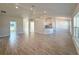 Spacious living area with wood-look tile flooring and recessed lighting throughout the space at 9869 Se 157Th Ln, Summerfield, FL 34491