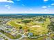 An aerial view showcasing a house's location near a golf course at 12576 Se 97Th Terrace Rd, Summerfield, FL 34491
