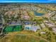 Aerial view of a community with a pool, tennis courts, clubhouse, and golf course at 12576 Se 97Th Terrace Rd, Summerfield, FL 34491