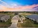 Aerial view of a house with sunset view over golf course at 12576 Se 97Th Terrace Rd, Summerfield, FL 34491