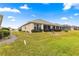 Expansive backyard with a well-maintained lawn and mature landscaping, perfect for outdoor activities at 12576 Se 97Th Terrace Rd, Summerfield, FL 34491