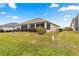House's backyard with grassy area at 12576 Se 97Th Terrace Rd, Summerfield, FL 34491