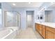 Spa-like bathroom with double sinks, shower, and large tub at 12576 Se 97Th Terrace Rd, Summerfield, FL 34491