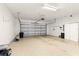 Clean and spacious garage with epoxy flooring, storage cabinets, and an automatic door opener at 12576 Se 97Th Terrace Rd, Summerfield, FL 34491