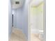 Hallway with light blue walls and tile flooring at 12576 Se 97Th Terrace Rd, Summerfield, FL 34491