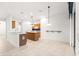 Open kitchen with island, wood cabinets, and breakfast bar at 12576 Se 97Th Terrace Rd, Summerfield, FL 34491