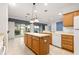 Spacious kitchen with an island and white appliances at 12576 Se 97Th Terrace Rd, Summerfield, FL 34491