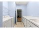 Spacious laundry room featuring modern washer, dryer, and counter space with a sink at 12576 Se 97Th Terrace Rd, Summerfield, FL 34491