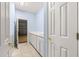 Bright laundry room adjacent to garage entry features cabinets, countertop, and utility sink at 12576 Se 97Th Terrace Rd, Summerfield, FL 34491