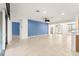 Spacious living room featuring tile floors and blue accent wall at 12576 Se 97Th Terrace Rd, Summerfield, FL 34491
