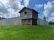 Exterior view of an historic wooden structure on a lush green lawn against a bright sky at 3127 Ne 45Th Ave, Ocala, FL 34470