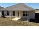 Covered back porch features neutral colors, space for entertaining, and an access door at 3127 Ne 45Th Ave, Ocala, FL 34470