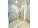 An elegant walk-in shower featuring glass doors, beautiful tile, and modern fixtures at 3127 Ne 45Th Ave, Ocala, FL 34470