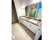 Bathroom featuring a double vanity, granite countertops, large mirror and lighting, and a walk-in shower at 3127 Ne 45Th Ave, Ocala, FL 34470