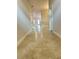 A long hallway with beautiful tiles connecting the front door to the rest of this open floor plan home at 3127 Ne 45Th Ave, Ocala, FL 34470