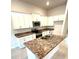 Modern kitchen with white cabinets, stainless steel appliances, and granite countertops with an island and sink at 3127 Ne 45Th Ave, Ocala, FL 34470