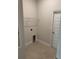 Neutral laundry room with tile flooring, overhead shelving, and hookups ready for appliances at 3127 Ne 45Th Ave, Ocala, FL 34470