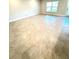 A living room with beautiful tiles, a large window letting in lots of light, and a glass patio door at 3127 Ne 45Th Ave, Ocala, FL 34470