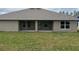 Rear exterior of home with a large yard and covered patio at 7143 Sw 179Th Court Rd, Dunnellon, FL 34432
