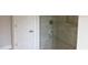 Modern glass enclosed shower with tile walls and a white door at 7143 Sw 179Th Court Rd, Dunnellon, FL 34432