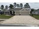Beautiful single-story home with brick driveway, a two-car garage, and inviting front lawn at 7143 Sw 179Th Court Rd, Dunnellon, FL 34432
