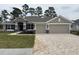 Charming single-story home with a two-car garage and inviting front lawn at 7143 Sw 179Th Court Rd, Dunnellon, FL 34432