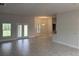 Bright, open-concept living room with tile flooring and backyard access at 7143 Sw 179Th Court Rd, Dunnellon, FL 34432