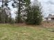 Secluded backyard with mature trees and green lawn creating a tranquil and private outdoor space at 7173 Sw 179Th Court Rd, Dunnellon, FL 34432