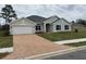 Charming one-story home with a brick driveway, lush green lawn, and a two-car garage at 7173 Sw 179Th Court Rd, Dunnellon, FL 34432