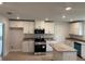Modern kitchen featuring stainless steel appliances, granite countertops, and white cabinetry at 7173 Sw 179Th Court Rd, Dunnellon, FL 34432