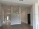 Spacious living room showcasing tile floors, recessed lighting, and an elegant chandelier at 7173 Sw 179Th Court Rd, Dunnellon, FL 34432
