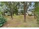 Large grassy backyard with mature trees and shrubbery providing privacy at 9068 Sw 82Nd Ter # A, Ocala, FL 34481