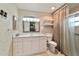 Bathroom with large vanity, decorative wallpaper, and a shower with curtains at 9068 Sw 82Nd Ter # A, Ocala, FL 34481