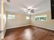 Bedroom features a ceiling fan, hardwood floors, neutral paint, and natural light at 9068 Sw 82Nd Ter # A, Ocala, FL 34481