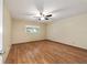 This bedroom features wood flooring, a ceiling fan and a window with a view at 9068 Sw 82Nd Ter # A, Ocala, FL 34481