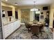Bright dining area with chandelier, table and chairs, and custom cabinets with granite counters at 9068 Sw 82Nd Ter # A, Ocala, FL 34481