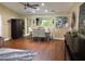 Dining room features wood floors, ceiling fan, table and chairs with large armoire and art at 9068 Sw 82Nd Ter # A, Ocala, FL 34481