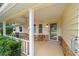 Inviting covered porch with stone accents, a ceiling fan, and a glass front door at 9068 Sw 82Nd Ter # A, Ocala, FL 34481
