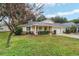 Charming home with a well-manicured front yard, a driveway and an attached garage at 9068 Sw 82Nd Ter # A, Ocala, FL 34481